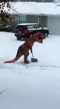 A dinosaur is shoveling snow. No, you are not seeing things.