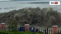 Crowds of people run for their lives as tidal wave crashes over flood defences