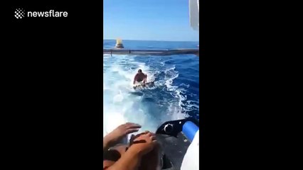 Water skiing at sea on a building pallet