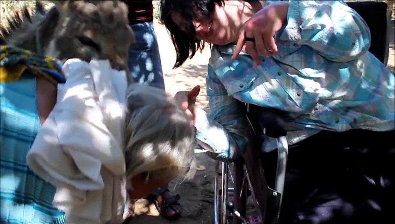 Animal lover with cerebral palsy feeds berries to TeddyBear