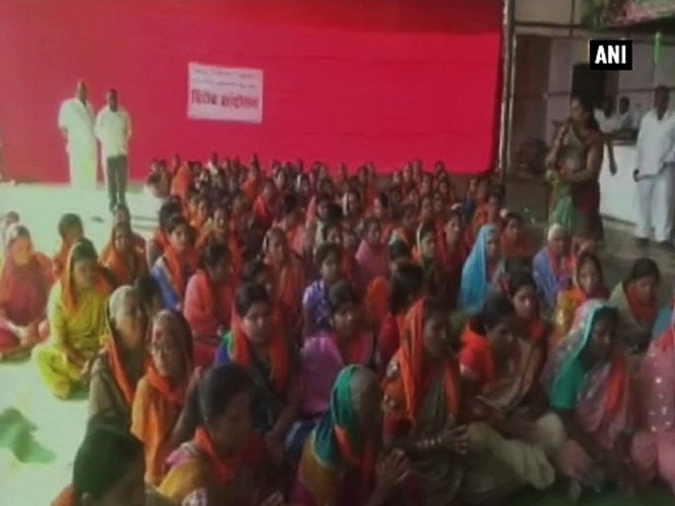 Local women gather outside Shani Shingnapur to bar women activists