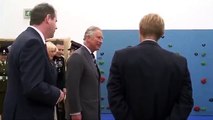 The Prince of Wales tries out a climbing wall at Grainville School in Jersey