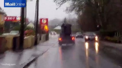 A person trying to move a sofa in the midst of Storm Desmond