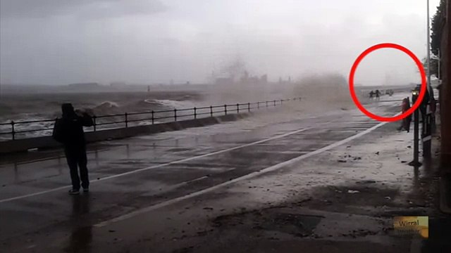 Close Call: People risk their lives to wave watch at Egremont, Wirral. Storm Jonas Uk. 26th January