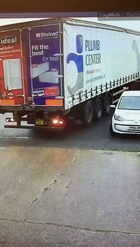 Truck driver destroying car while trying to leave his parking lot