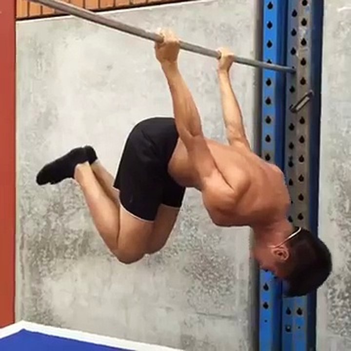 Guy Holds Himself Up Backwards on Pole
