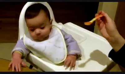 Funny baby eating carrots for the first time