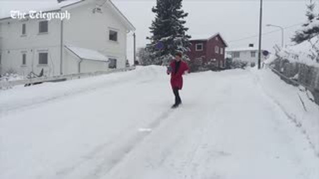 Norwegian man slides down hill in slow-motion with coffee