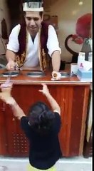 Ice cream shopkeeper tricks with child