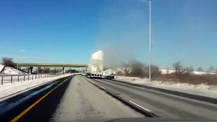 Snow blows off a truck's roof...