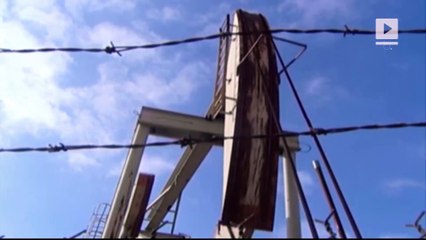 Exxon, top in stock buybacks, now saving its cash