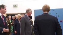 The Prince of Wales tries out a climbing wall at Grainville School in Jersey