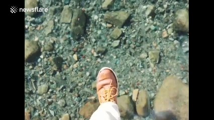 Walking on a frozen lake with crystal clear ice