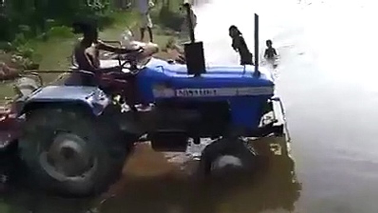 Tractor Crosses A River