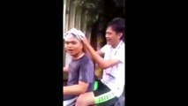 Man gets his head hair washed with shampoo and massaged while driving a scooter in Taiwan