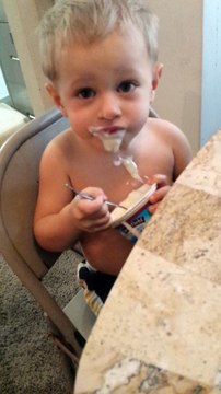 2 Yr. Old Child Trying to Eat Pudding and Enjoying Eating it So Much He Wears Most of It!