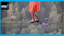a woman with heels on a rope making balance -funny video - omg video
