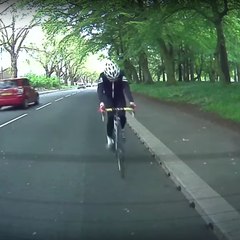 An absent-minded cyclist hits a parked car