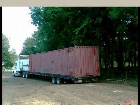 House built from steel shipping containers from transport truck