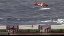 Coast Guard  helicopter medevacs two injured crewmen during storm.