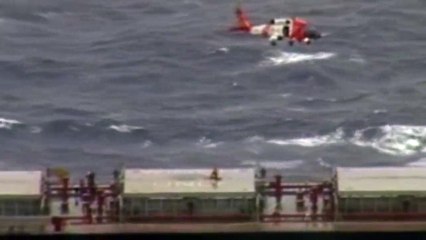 Coast Guard  helicopter medevacs two injured crewmen during storm.