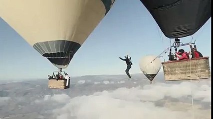 Man falls from tightrope walk between balloons