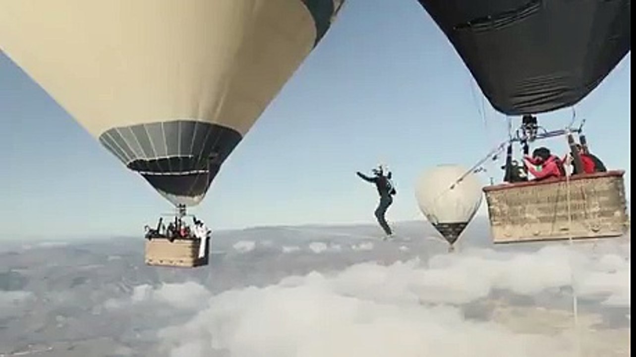 Man falls from tightrope walk between balloons