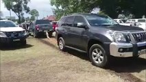 Truck tows parked four-wheel-drive after it parked in other car