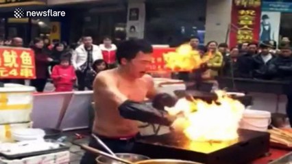 Shirtless man dances wildly while roasting squid