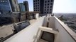 Watch as this crazy stunt man does front flips on a high rise roof top!