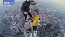 Don't look down: Moment climbers reach top of Shun Hing Tower