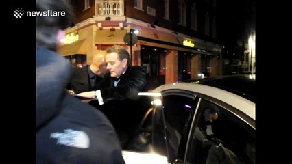 Bryan Cranston signs autographs for fans after a post-BAFTA party
