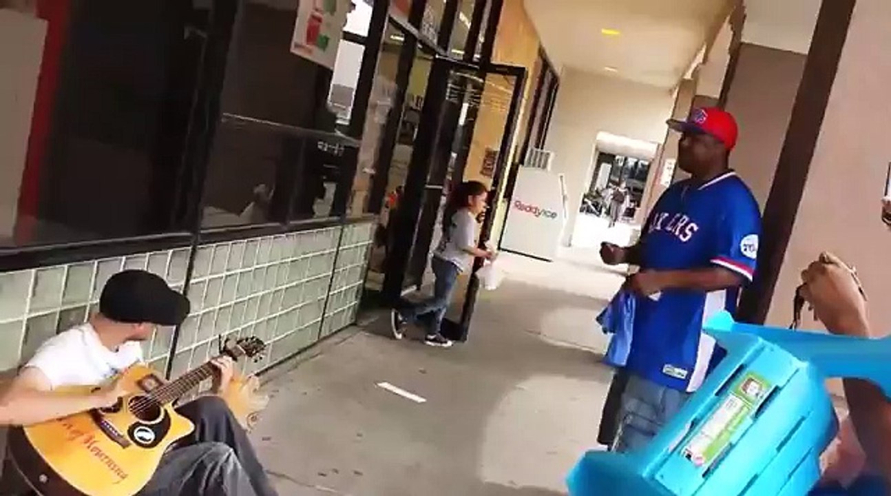 A man films this street musician when a strange...