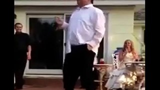A fat old man dancing infront of many peoples and drop his pent...