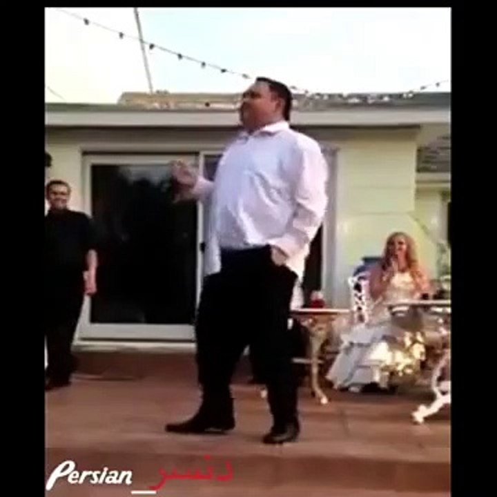 A fat old man dancing infront of many peoples and drop his pent...