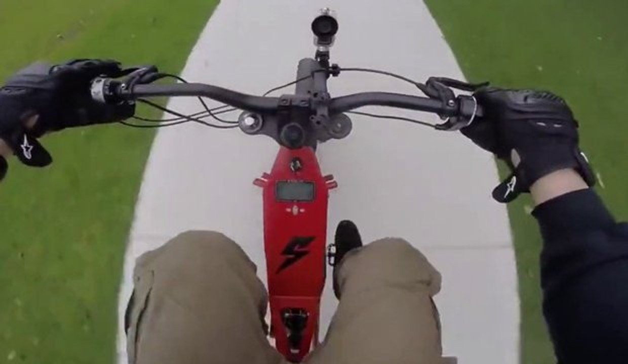 A man films his ride at 80km/h in the streets of Sydney on board his electric bike Bomber B-52.