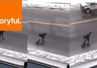 Download Video: Man Skates on Icy Streets With Suitcase