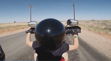 Un père fait conduire sa moto à  son fils