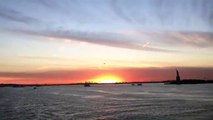 View the sunset from the a ferry at the Hudson River with the Statue of Liberty in the horizon. (News World)