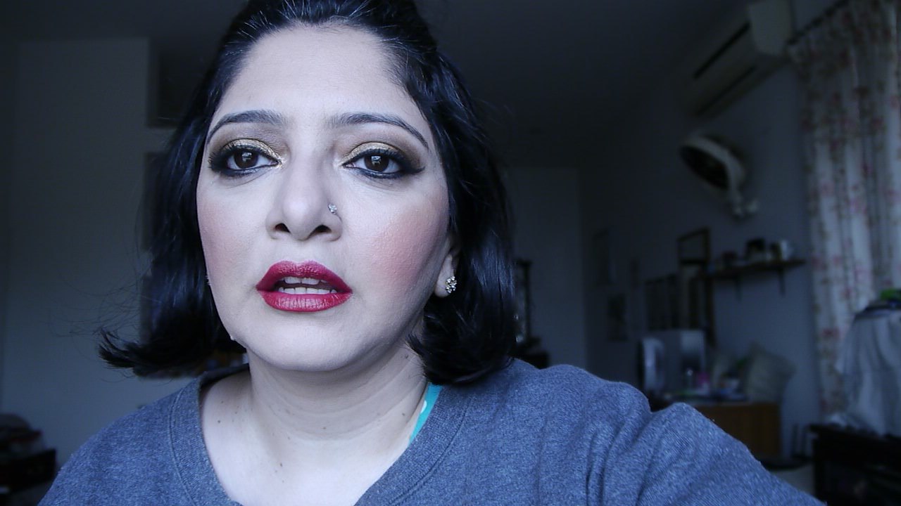 pakistani/indian bridal makeup with gold and bronze eyes with a red lip