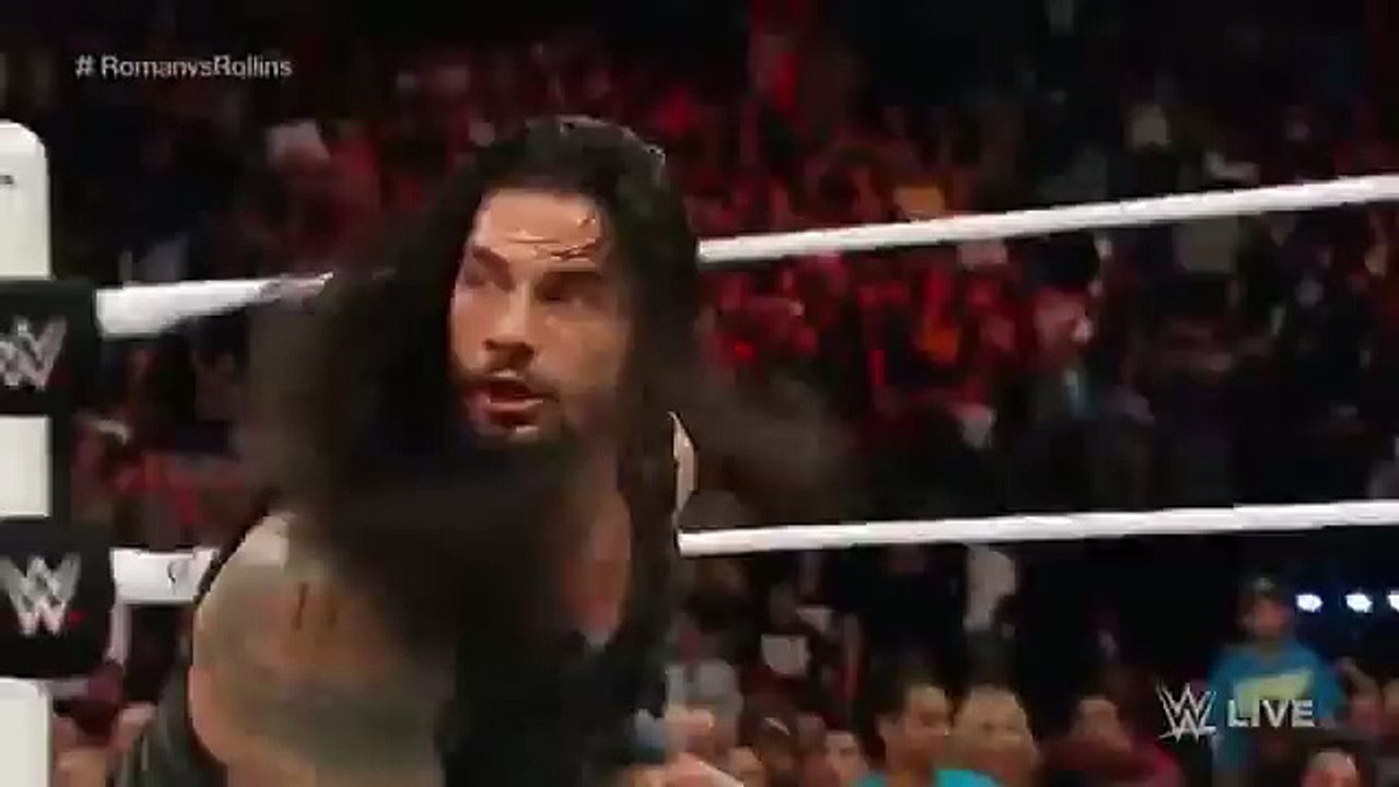 Roman Reigns dives over the top rope!