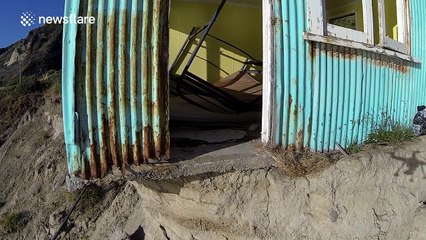 One last look at a house being swallowed by the sea