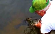 Guy Catches Huge Bass With His Hands!