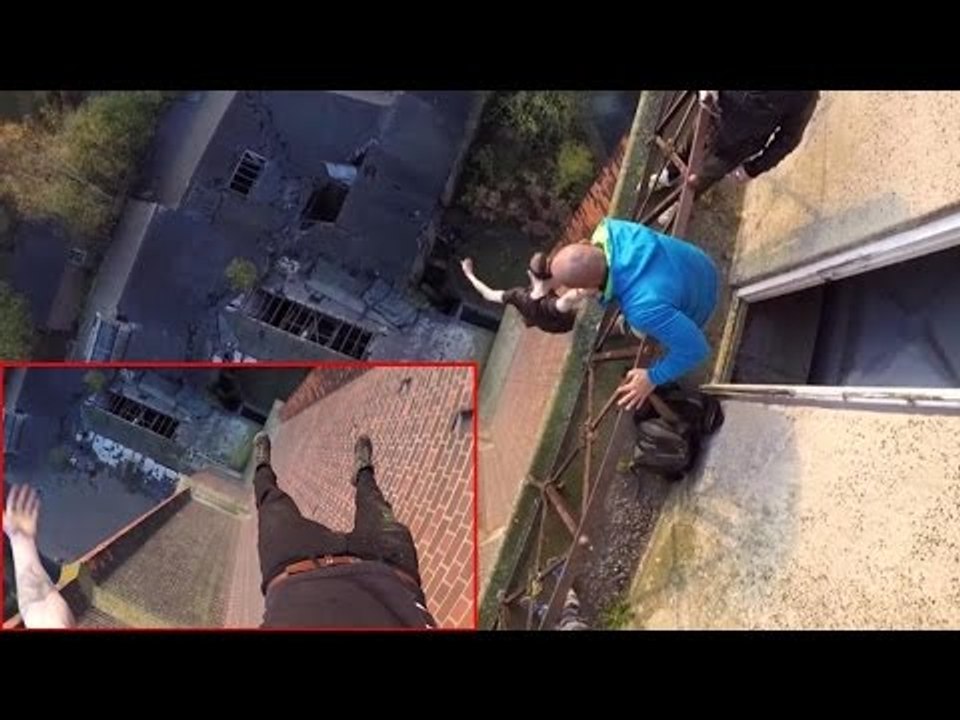Daredevil hangs from 150ft high tower with just...