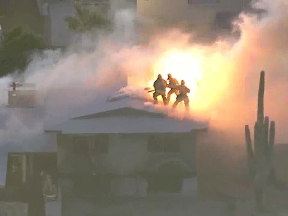 Firefighters battle flames at Phoenix house