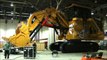 moving huge Caterpillar 6030B excavator