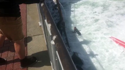 Waves Crash into Surfer during High Tide