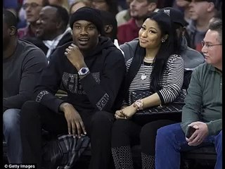 Nicki Minaj finds time for make-up touch up while sitting front row