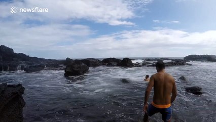 Stop-motion footage of a wave wiping out some people in Hawaii