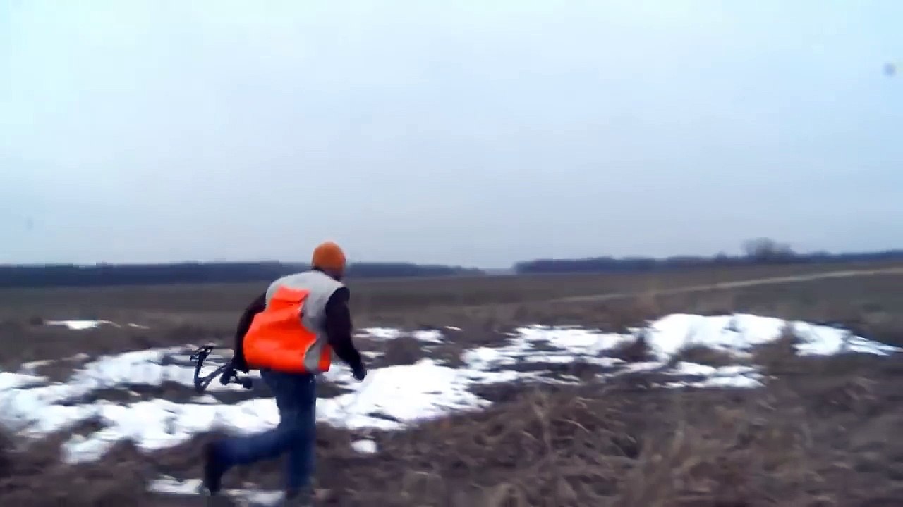 Hunter throws his bow at a pheasant when it runs away with an arrow stuck in it
